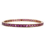 Unmarked gold ruby hinged bangle, possibly Victorian, tests as 15ct gold, 5.7cm in diameter, 12.0g :