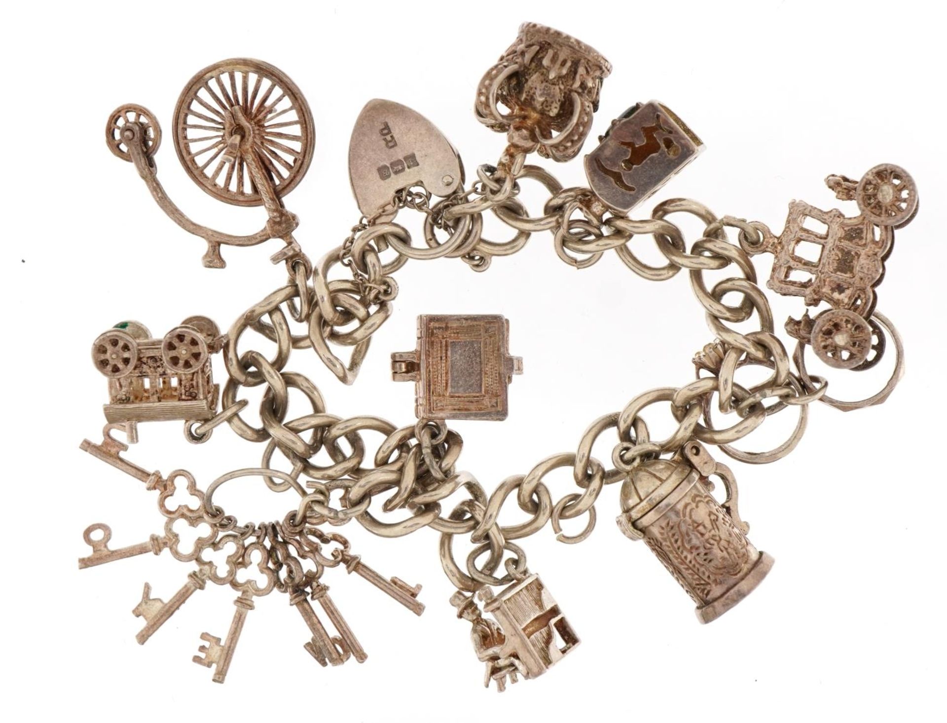 Silver charm bracelet with a selection of mostly silver charms including Penny Farthing, carriage - Image 2 of 3