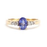 14k gold tanzanite and diamond ring with stepped shoulders, the tanzanite approximately 6.4mm x 4.