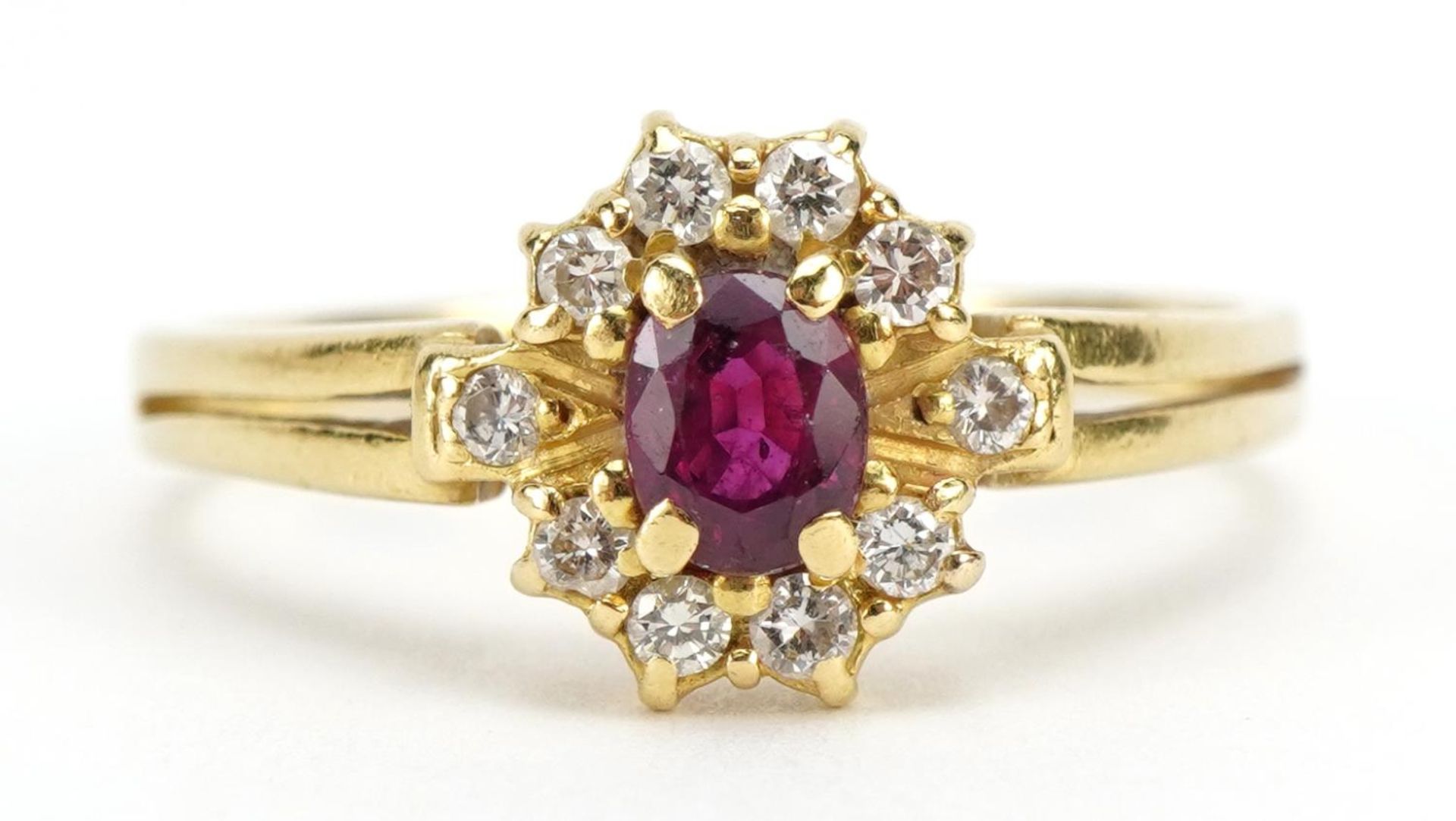 18ct gold ruby and diamond cluster ring, the ruby approximately 5.0mm x 3.9mm, size S/T, 4.0g :