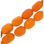 Butterscotch amber coloured graduated bead necklace, the largest bead 2.1cm in length, 42cm in