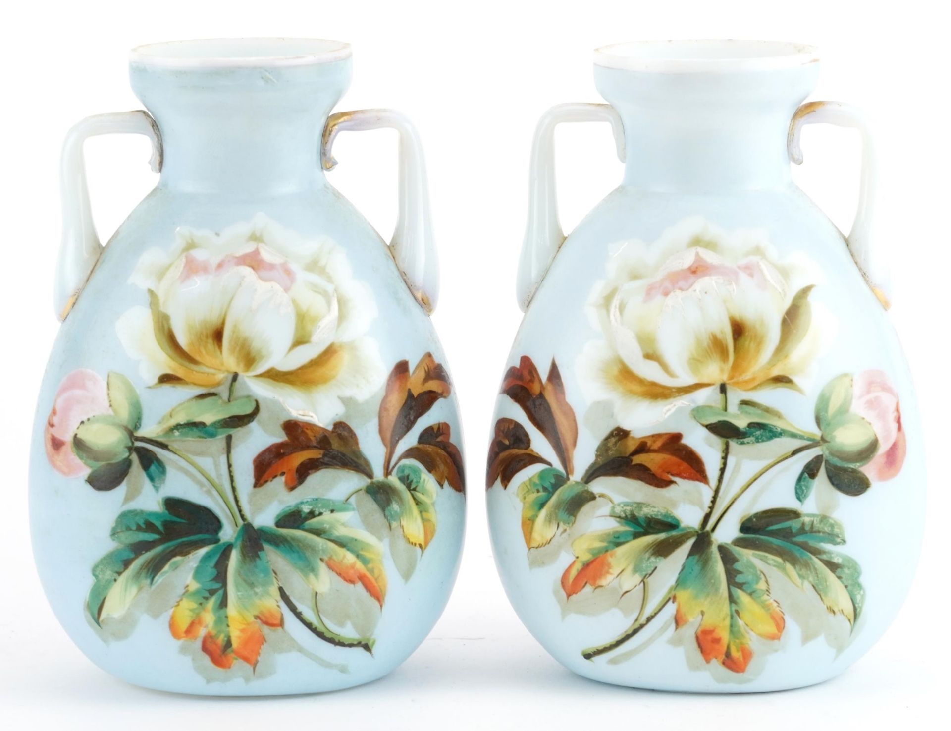 Pair of 19th century opaline glass vases with twin handles, each hand painted with flowers, 17cm