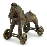 Chinese patinated bronze push along horse, 18cm high : For further information on this lot please