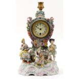 German porcelain floral encrusted mantle clock with candleholder surmounted with three figures