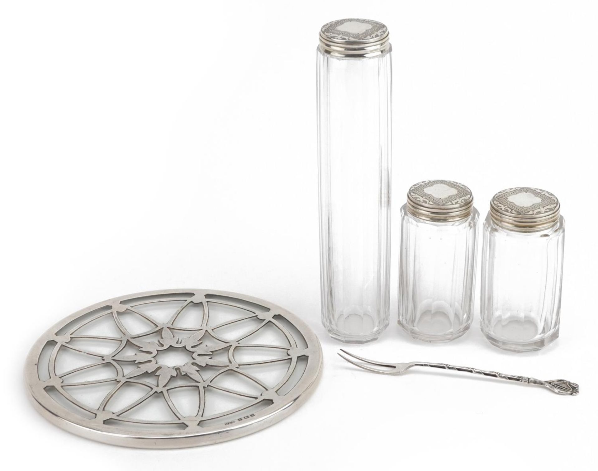 Three Victorian cut glass jars with silver lids, silver overlaid glass coaster and a silver fork,