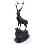 Large patinated bronze stag raised on a black marble base, 73cm high : For further information on