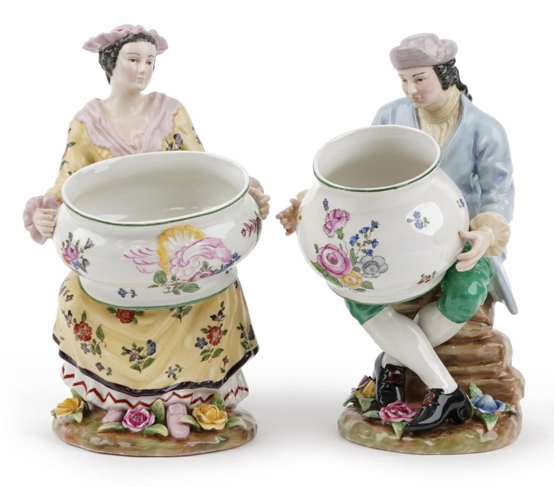 Manner of Sevres, pair of continental porcelain figures, each holding a bowl, the largest 30cm
