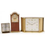 Three vintage brass cased Swiza clocks including one in the form of a Tempus Fugit longcase, the