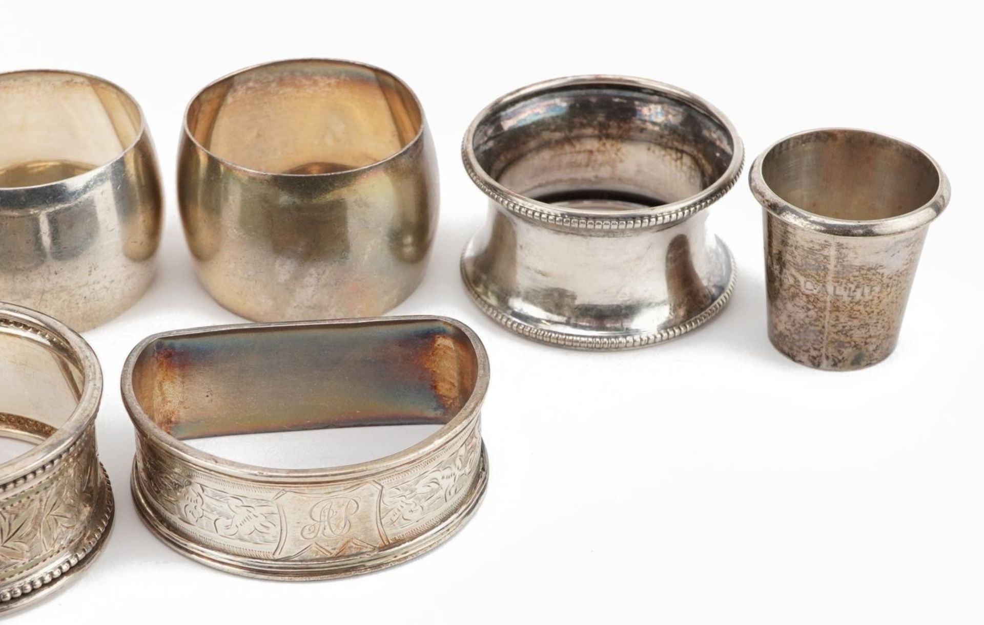 Seven Victorian and later silver napkin rings and a sterling silver thimble cup, the largest 5.5cm - Image 3 of 4