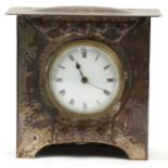 Arts & Crafts silver plated copper mantle clock embossed with flower heads having a circular dial