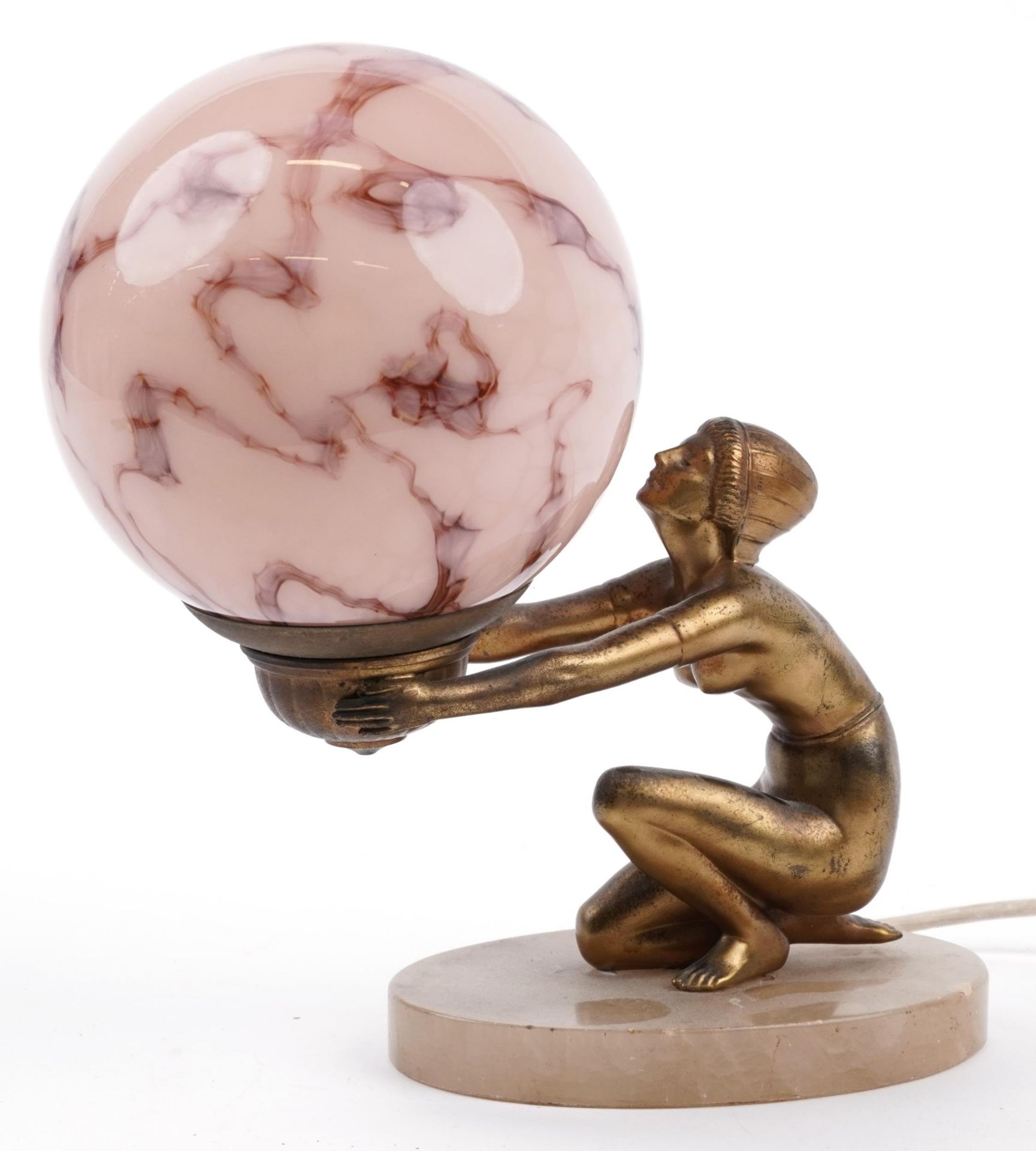 Art Deco gilt metal figural table lamp in the form of a nude female with globular pink glass
