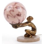 Art Deco gilt metal figural table lamp in the form of a nude female with globular pink glass