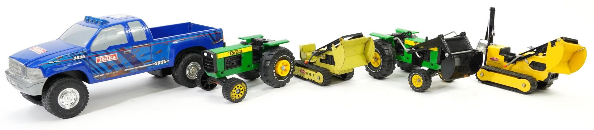 Four vintage Tonka tinplate agricultural vehicles and a large Tonka battery operated 4 X 4, the