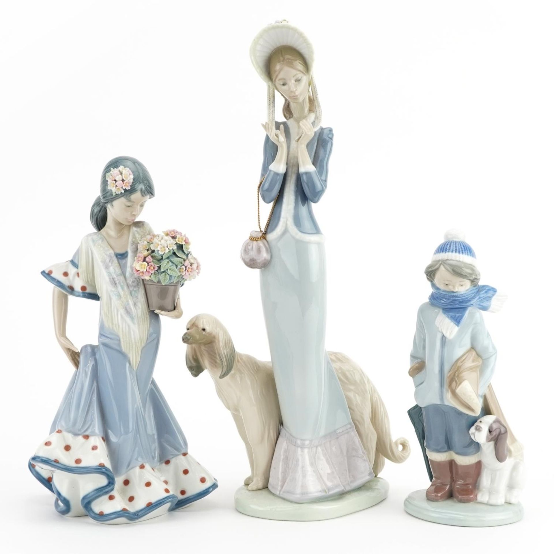 Three Lladro figures including a figurine of a female with Afghan Hound numbered 1537, the largest