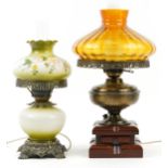 Two brass and glass table lamps in the form of oil lamps including one hand painted with flowers,