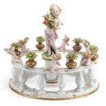 Italian Naples porcelain centrepiece in the form of Putti standing on a pillar surrounded by a