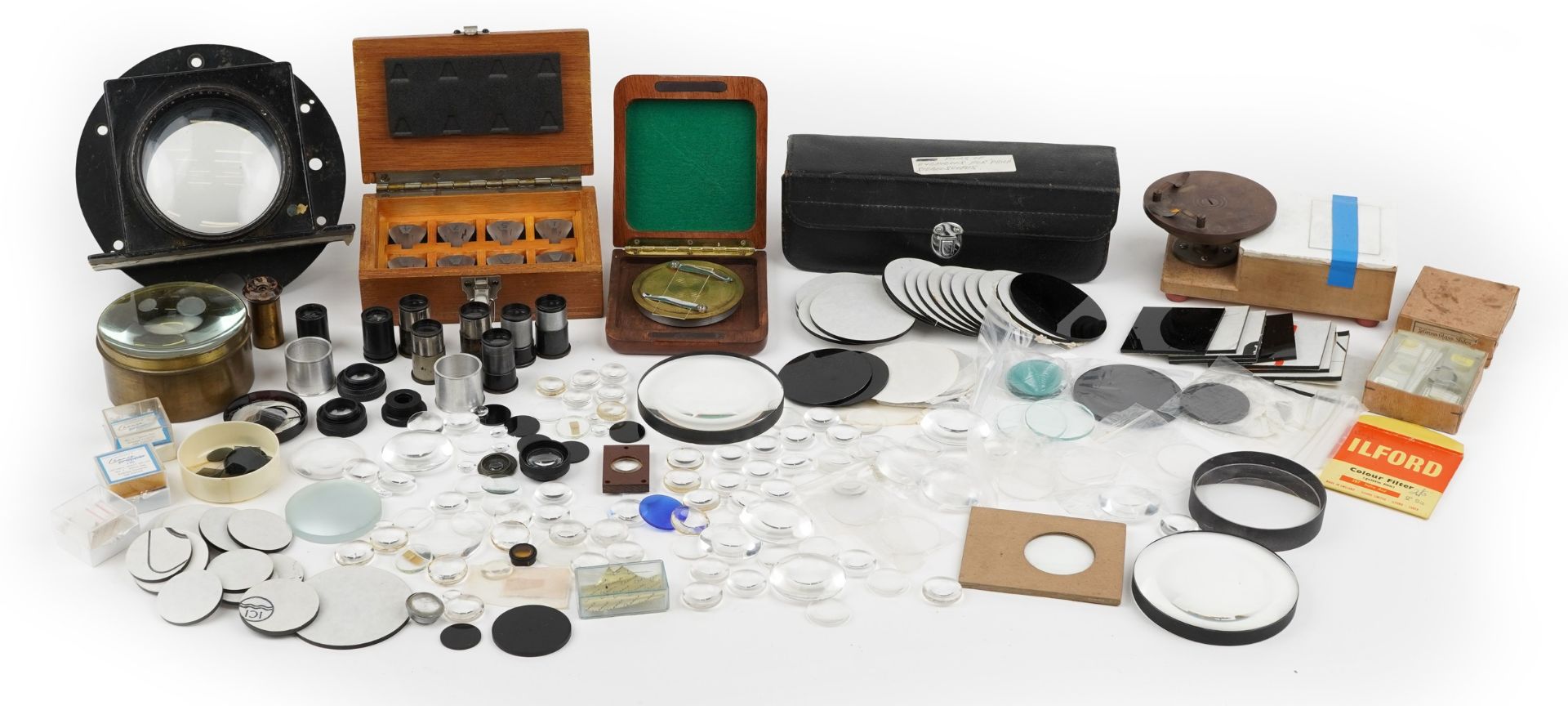 Collection of vintage and later optical accessories including lenses, reflector telescope