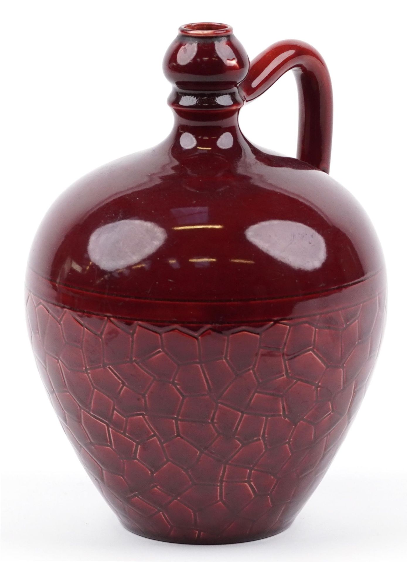 Manner of Bermantofts, Arts & Crafts handled flagon having a red glaze, incised marks and numbers to