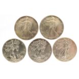 Five United States of America one ounce silver dollars comprising dates 1986, 1994, 2014, 2014 and