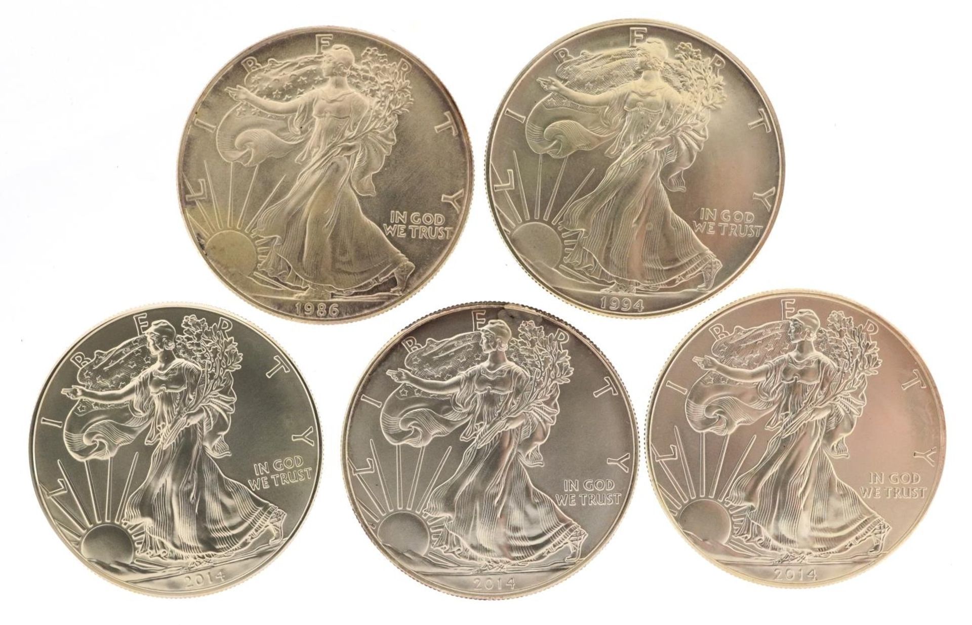 Five United States of America one ounce silver dollars comprising dates 1986, 1994, 2014, 2014 and