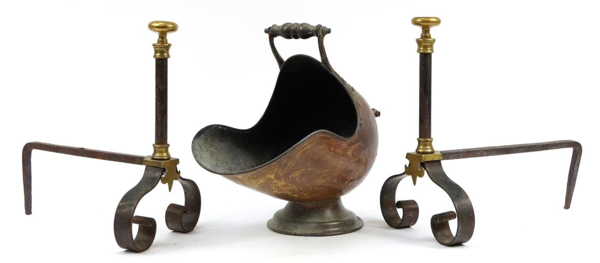 Victorian copper helmet shaped coal scuttle and a pair of cast iron and brass firedogs, the