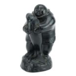 Innuit carving of an Eskimo holding a fish, paper label to the base, 16.5cm high : For further