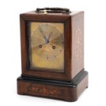 French inlaid rosewood travel clock striking on a bell with silvered dial having Roman numerals