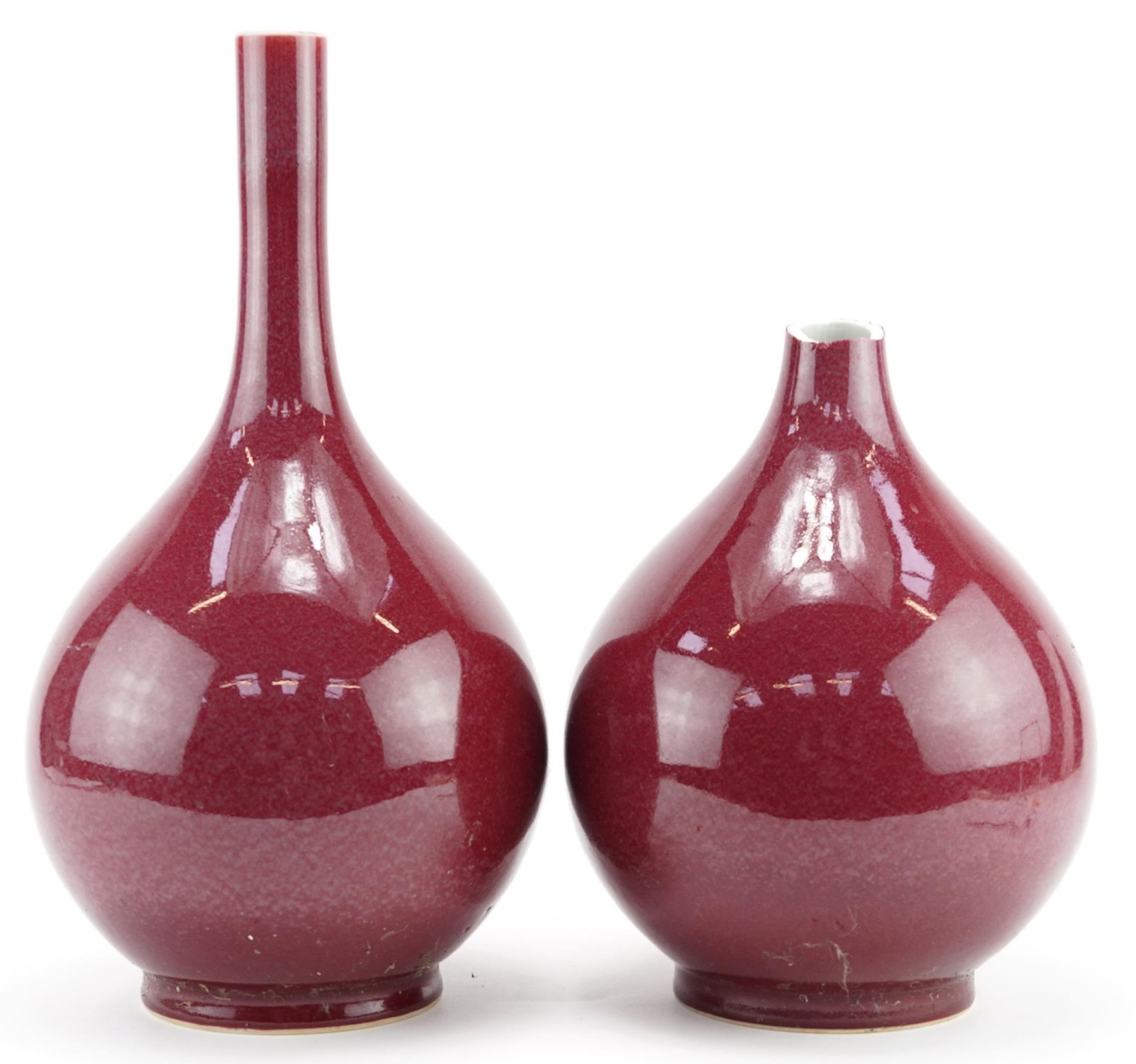 Pair of Chinese porcelain long neck vases having sang de boeuf glazes, each 34cm high : For