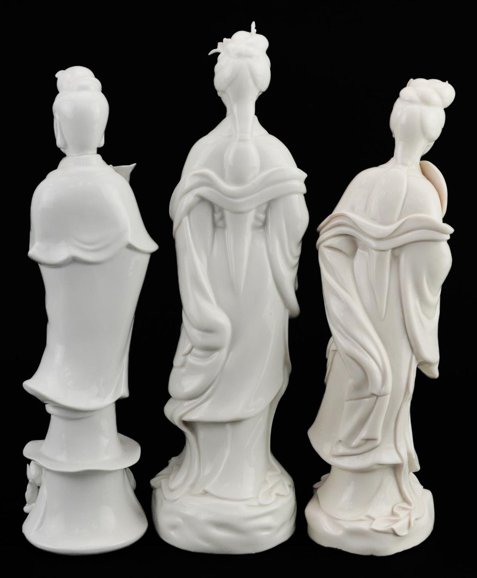 Three Chinese porcelain figures of Guanyin, each having a blanc de chine glaze, the largest 27cm - Image 2 of 3