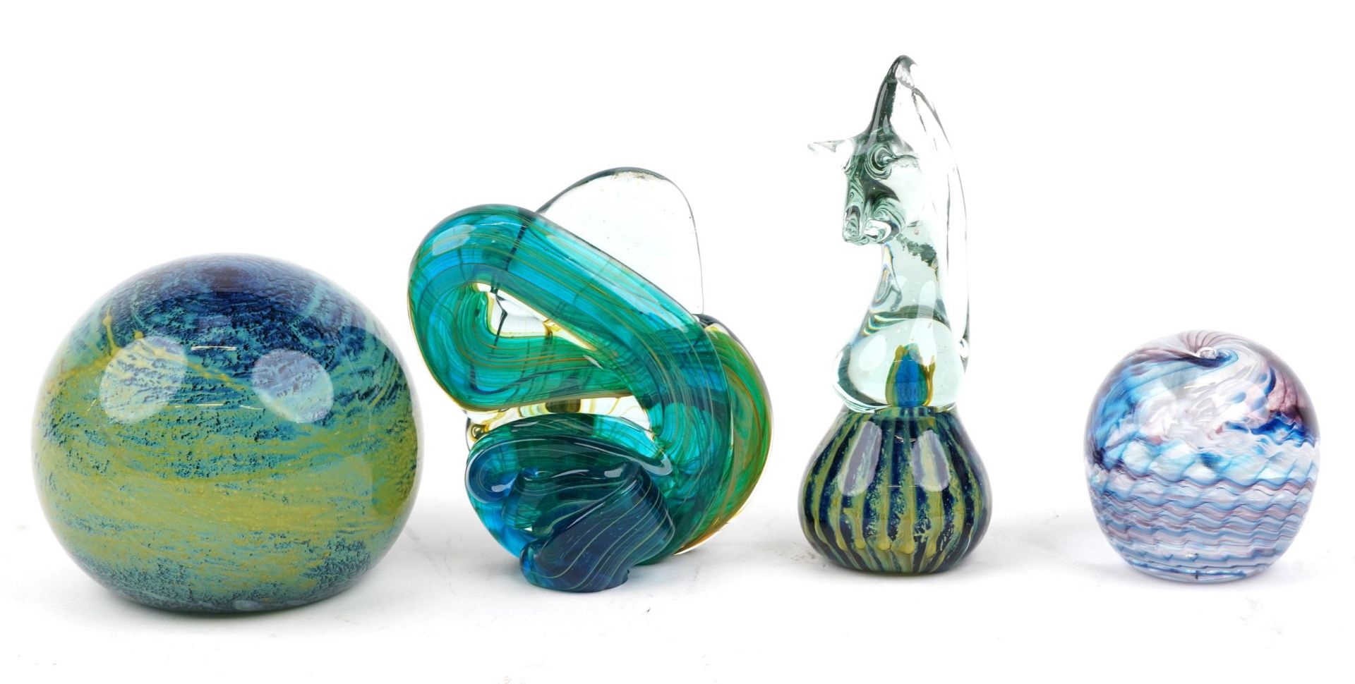 Three Mdina glass paperweights including a seahorse and one other by Saunders & Wallace, the largest