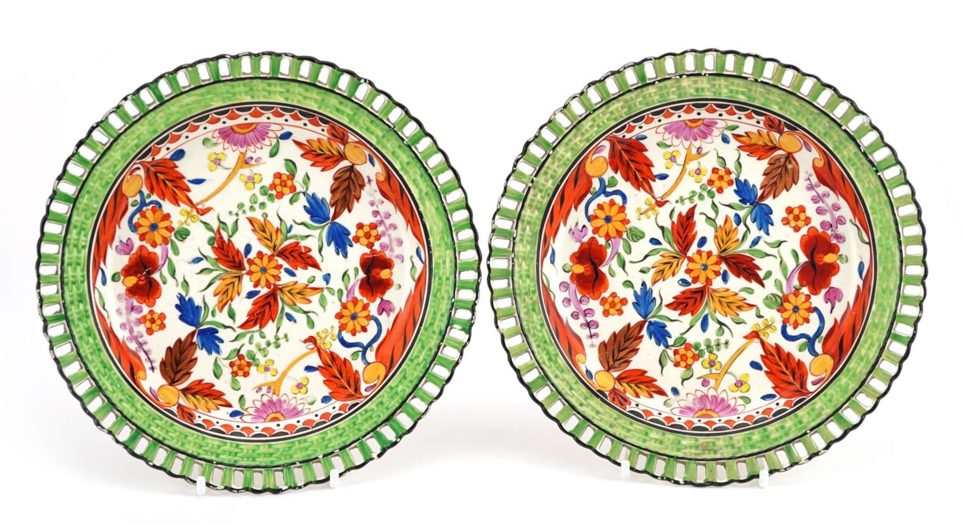 Pair of 19th century Creamware plates with pierced borders hand painted with flowers, each 19cm in