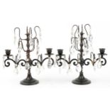 Pair of bronzed two branch lustre candelabrum with cut glass drops, 32cm high : For further