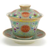 Chinese blue ground porcelain tea bowl and cover on stand hand painted in the famille rose palette