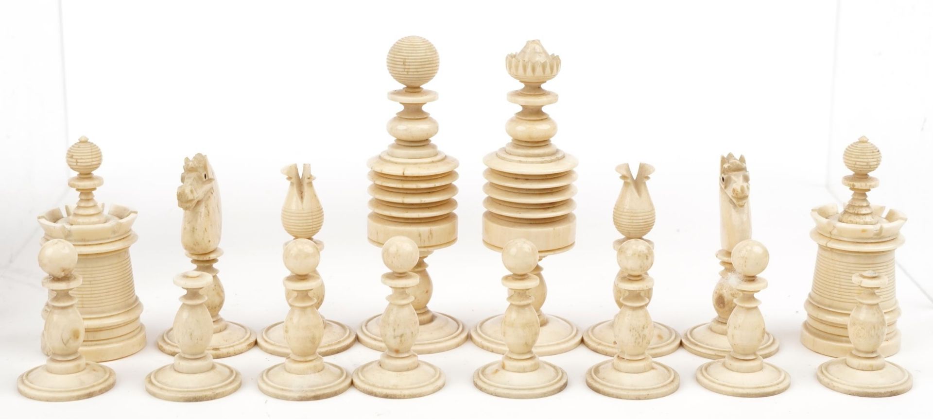 Half stained carved bone chess set with mahogany case having sliding lid, the largest pieces each - Image 3 of 6
