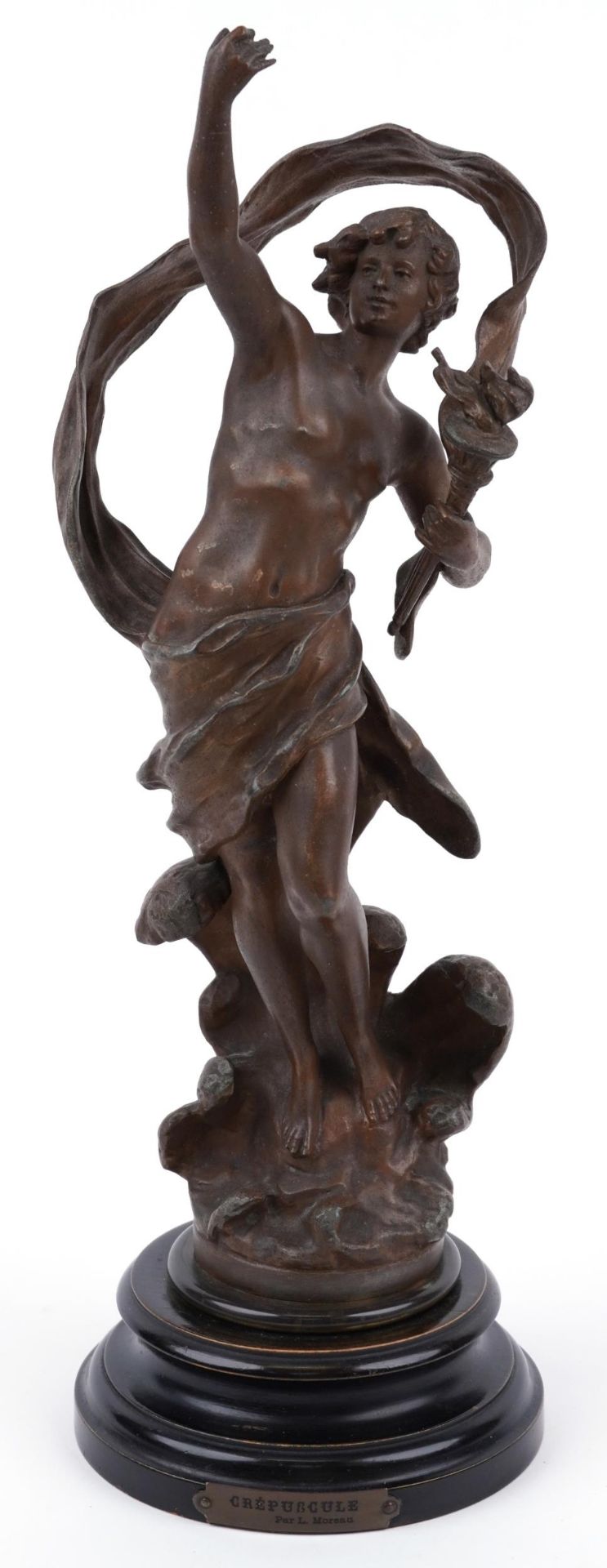 Patinated spelter study of a nude male holding a flaming torch raised on a circular ebonised base