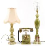 Two green onyx table lamps, one with shade and a vintage green onyx dial telephone, the largest 68cm
