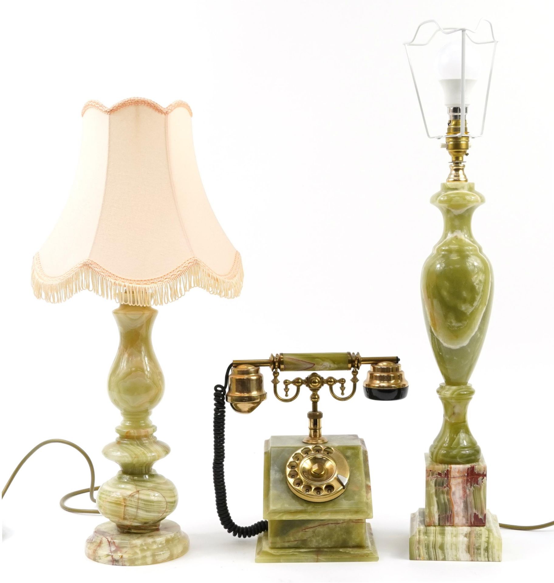 Two green onyx table lamps, one with shade and a vintage green onyx dial telephone, the largest 68cm