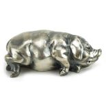 Silver model of a recumbent pig with ruby eyes, impressed Russian marks to the base, 7cm in