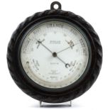 Carved oak wall barometer with thermometer retailed by Whyte & Co of Glasgow, 22.5cm in diameter :