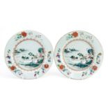 Pair of Chinese porcelain plates finely hand painted in the famille rose palette with a palace