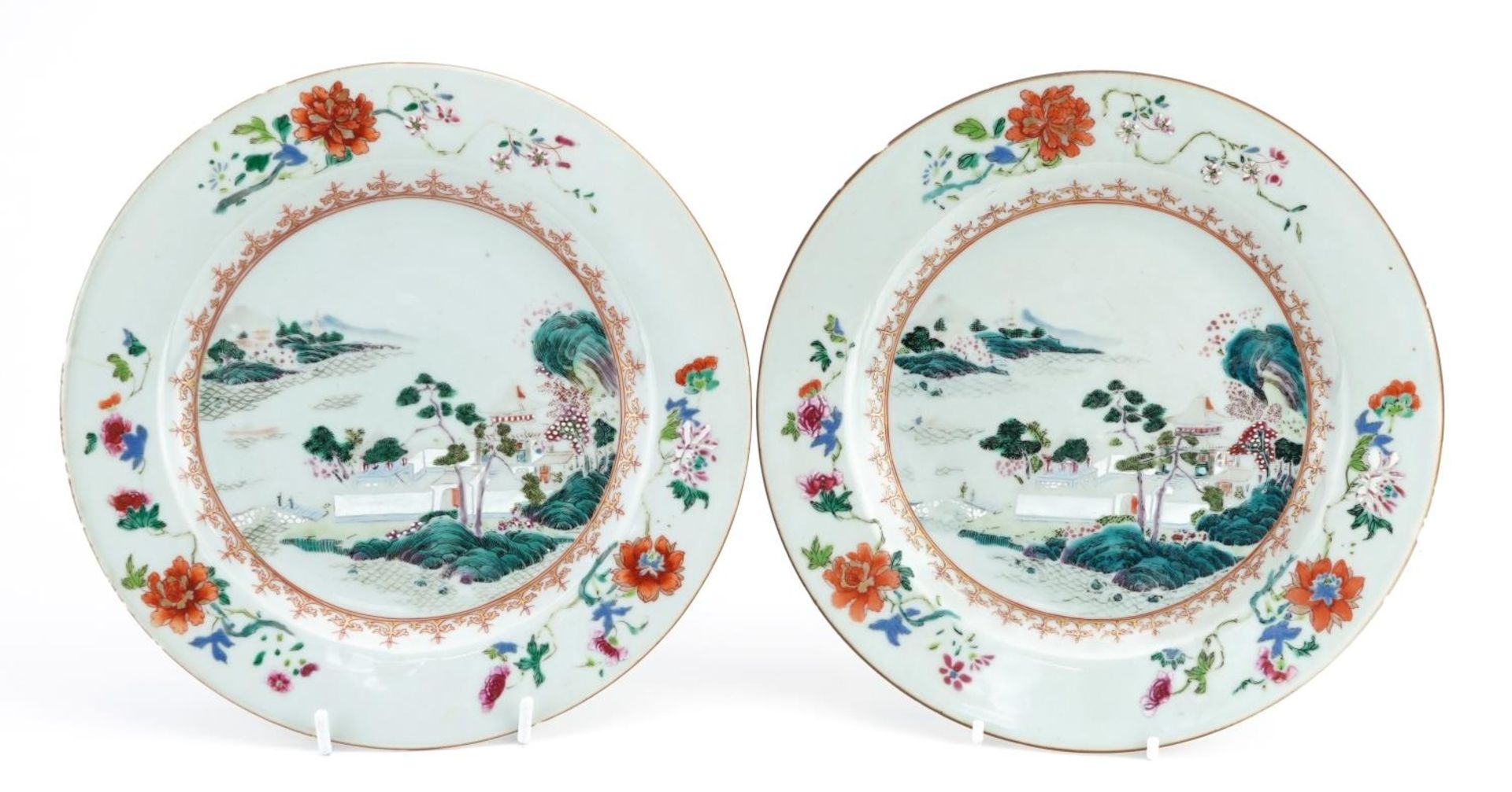 Pair of Chinese porcelain plates finely hand painted in the famille rose palette with a palace