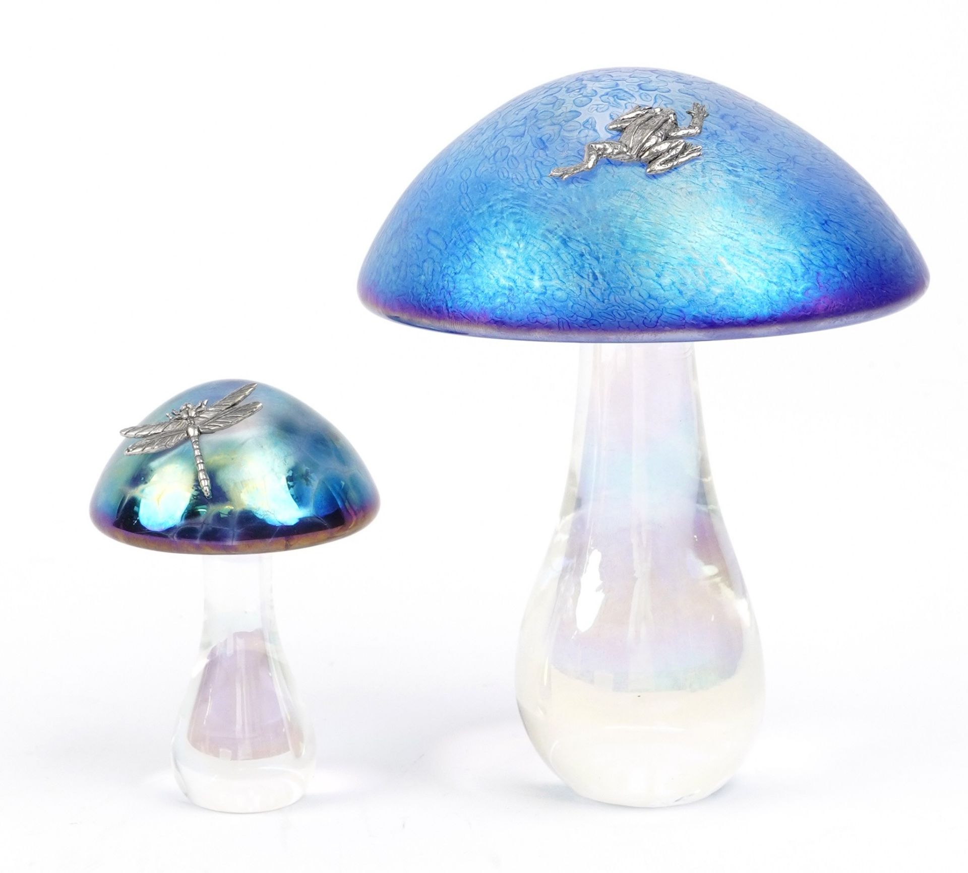 Manner of John Ditchfield, two iridescent toadstool glass paperweights mounted with a white metal