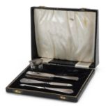 William Adams Ltd, George VI silver four piece vanity set with engine turned decoration housed in