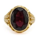 18ct gold garnet solitaire ring with scrolled shoulders, the garnet approximately 12.9mm x 9.7mm,