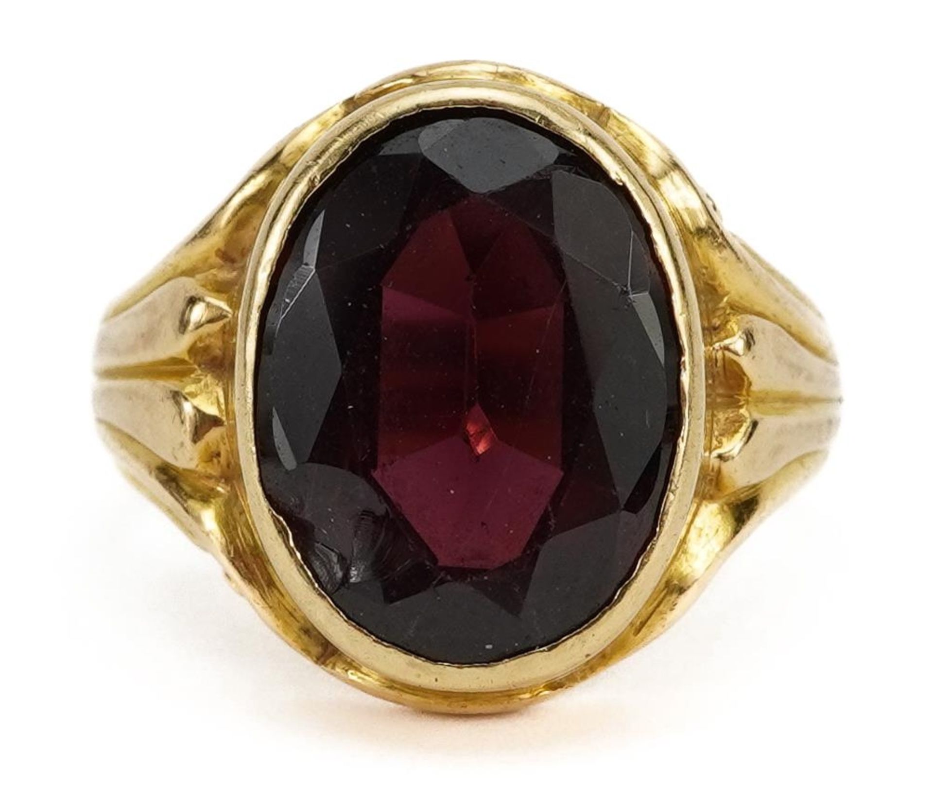 18ct gold garnet solitaire ring with scrolled shoulders, the garnet approximately 12.9mm x 9.7mm,