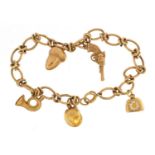 9ct gold charm bracelet with a selection of 9ct gold and yellow metal charms including revolver,