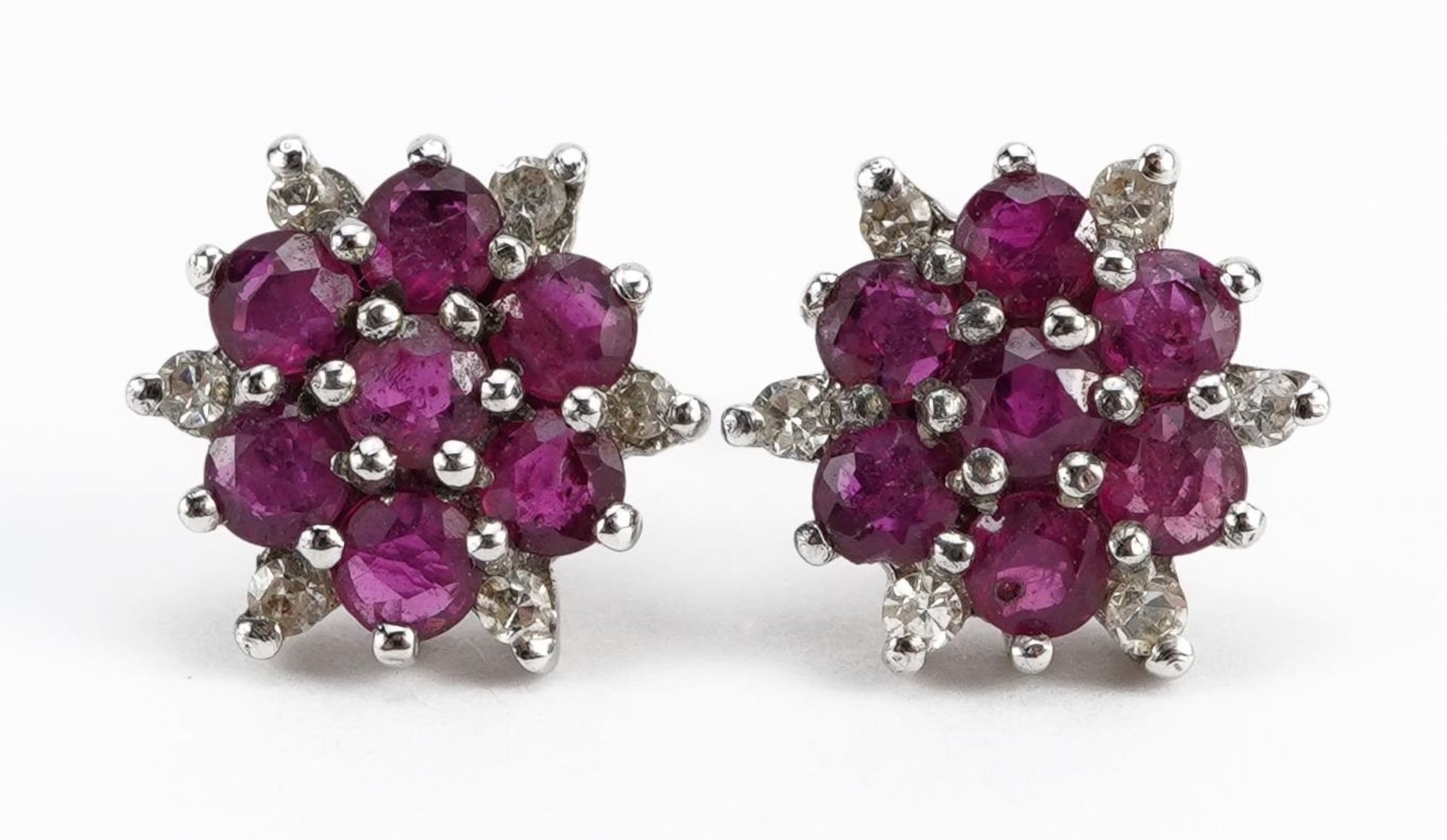 Pair of 9ct gold ruby and diamond cluster stud earrings, 1.0cm in diameter, 1.6g : For further