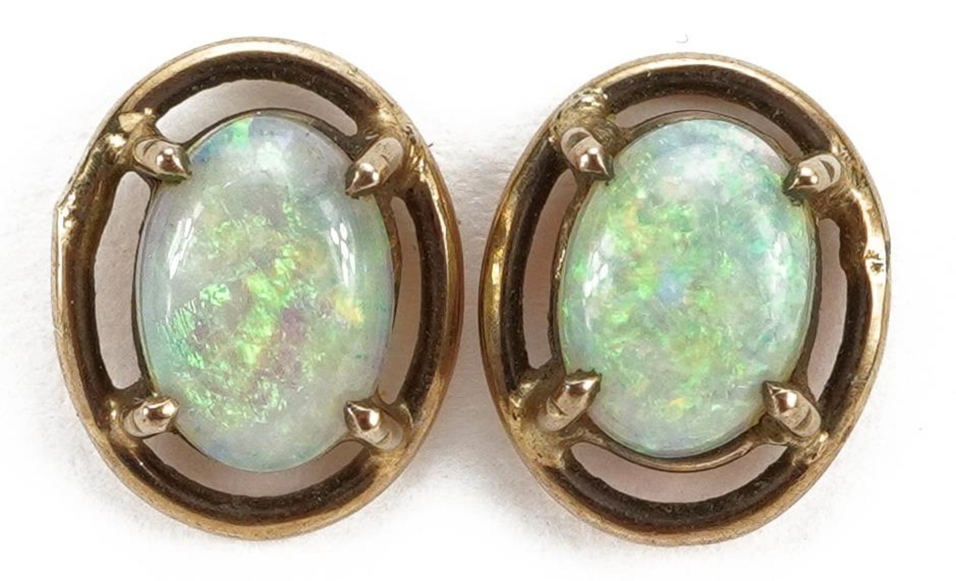 Pair of unmarked gold cabochon opal stud earrings, 1.0cm high, 1.1g : For further information on