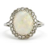 Platinum cabochon opal and diamond cluster ring housed in a Mappin & Webb Ltd tooled leather box,