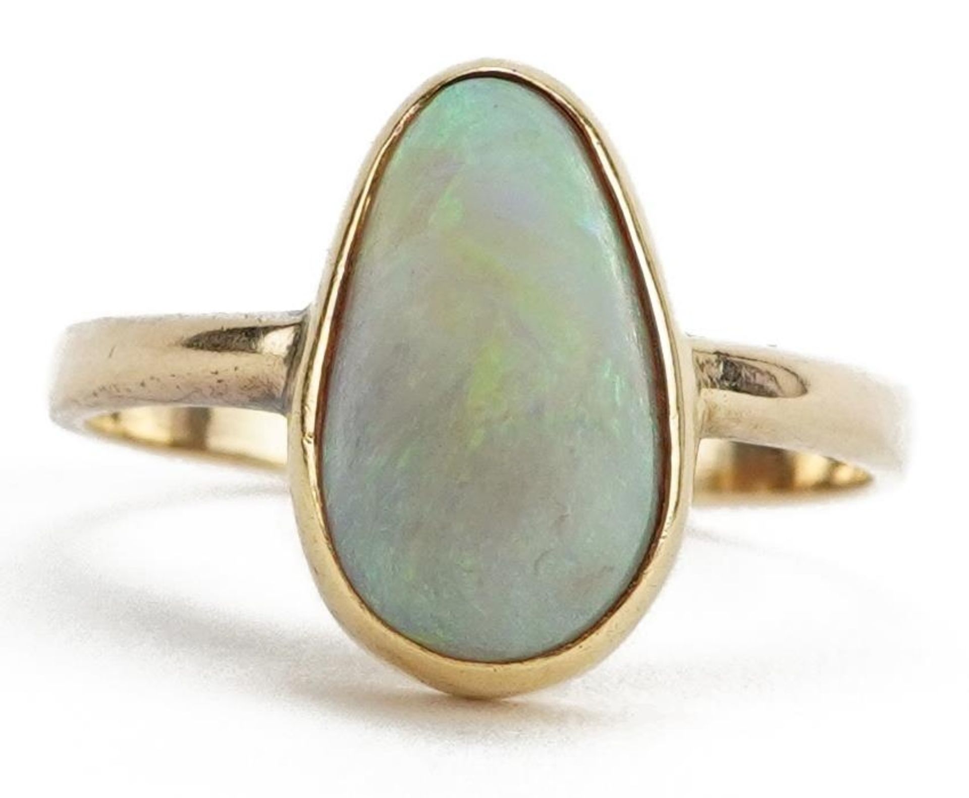 Unmarked gold cabochon opal ring, tests as 18ct gold, the opal approximately 12.0mm x 7.0mm, size O,